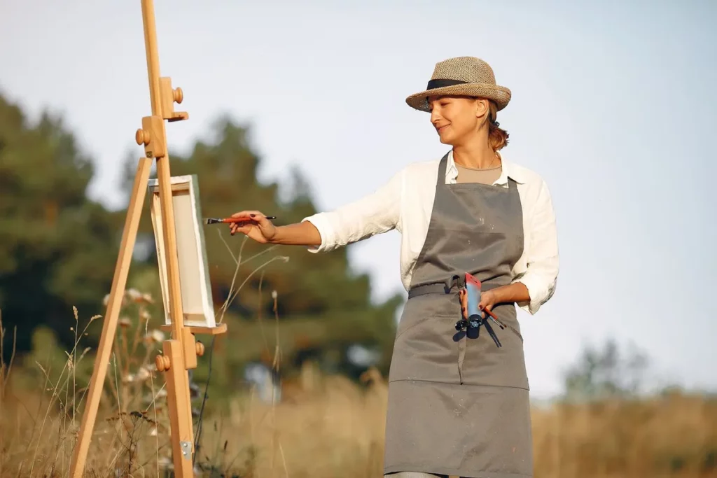 Peintre en plein air devant son chevalet, lumière d'été